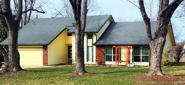 view of front facade with a front lawn, brick siding, a shingled roof, and an attached garage