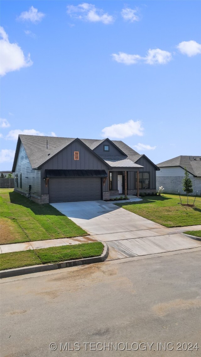 view of front facade with a front yard and a garage