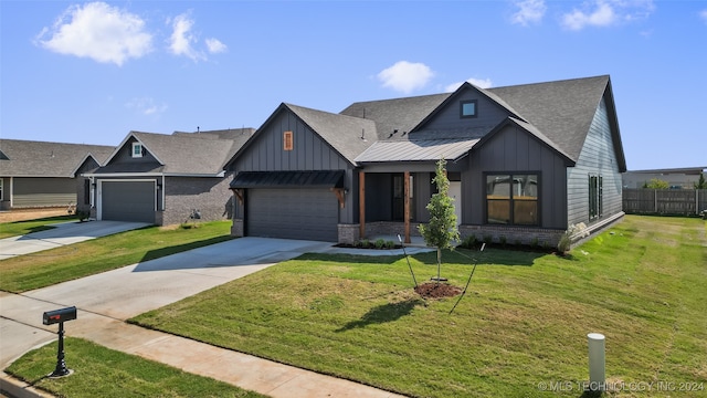 view of front of home with a front lawn and a garage