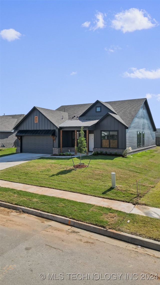 view of front of property with a garage and a front lawn