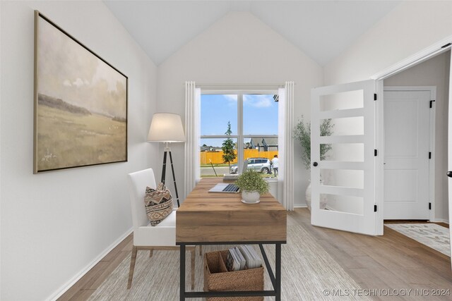 office space with light hardwood / wood-style flooring and lofted ceiling