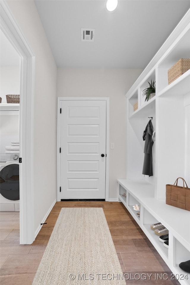 mudroom featuring light wood-type flooring and washer / clothes dryer