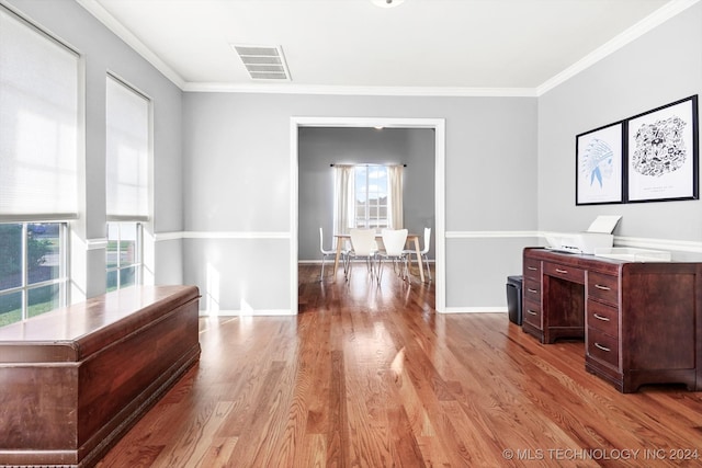 unfurnished office with crown molding and light hardwood / wood-style floors