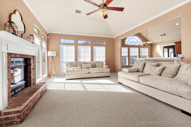 living room with high vaulted ceiling, a brick fireplace, ceiling fan with notable chandelier, crown molding, and light colored carpet