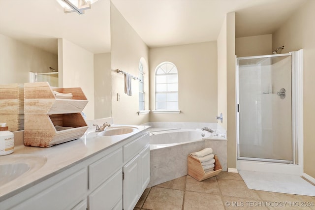 bathroom with independent shower and bath, vanity, and tile patterned floors