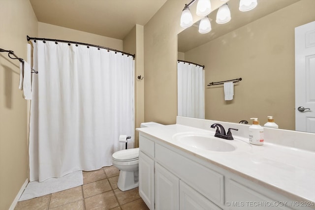 bathroom with vanity, tile patterned flooring, and toilet