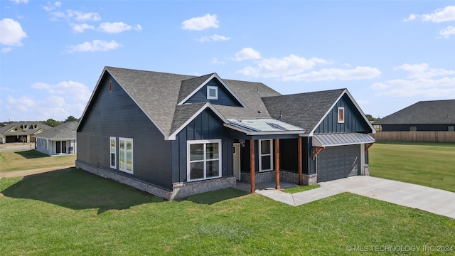 view of front of home with a garage and a front lawn