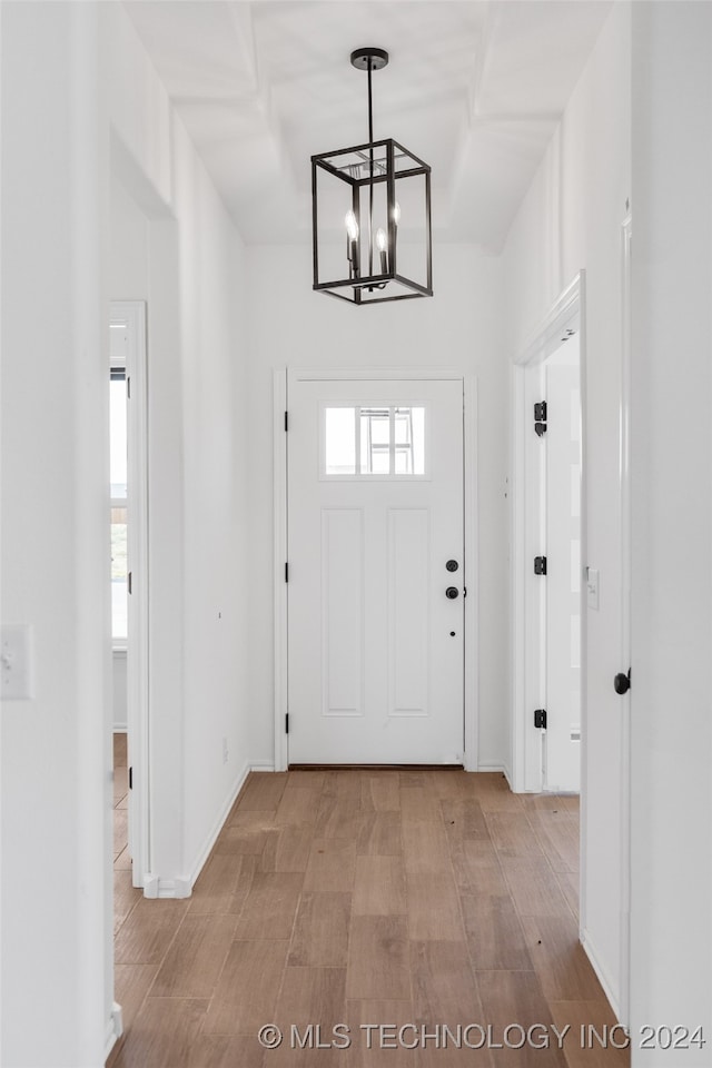 foyer featuring light hardwood / wood-style floors and an inviting chandelier