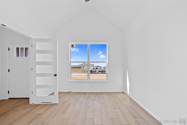 unfurnished living room with light hardwood / wood-style flooring and high vaulted ceiling