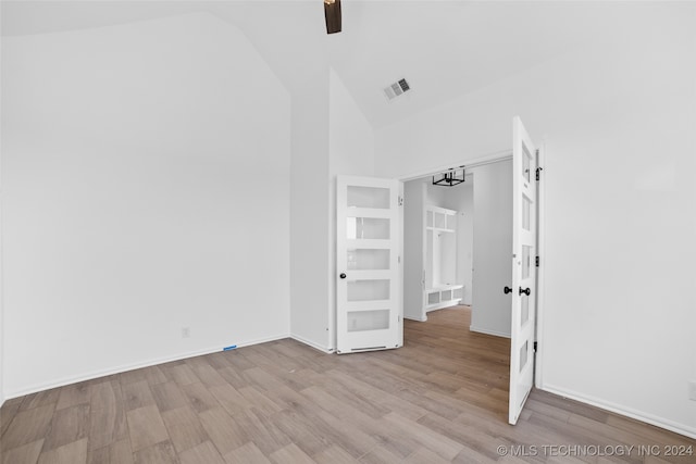 unfurnished bedroom with light hardwood / wood-style floors, high vaulted ceiling, and ceiling fan