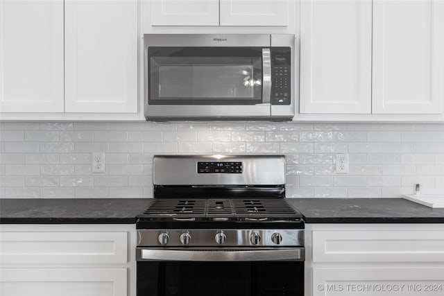 kitchen with decorative backsplash, white cabinets, and stainless steel appliances