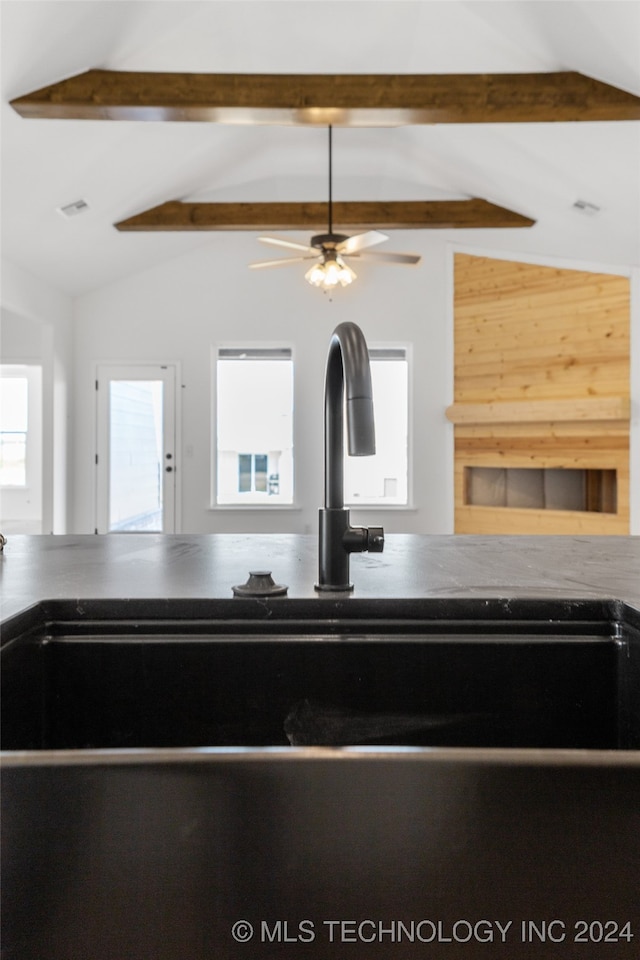 room details featuring beamed ceiling, sink, and ceiling fan