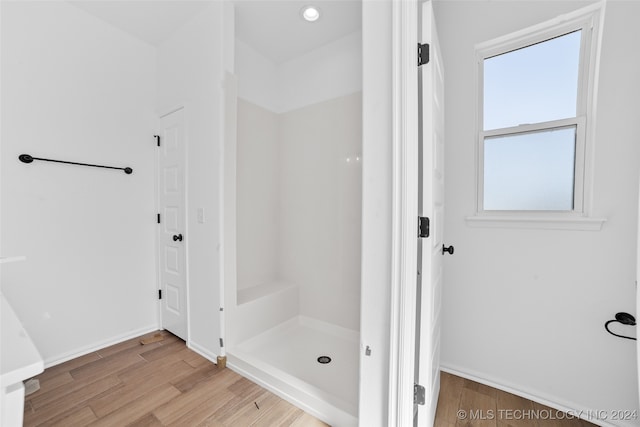 bathroom with wood-type flooring and walk in shower