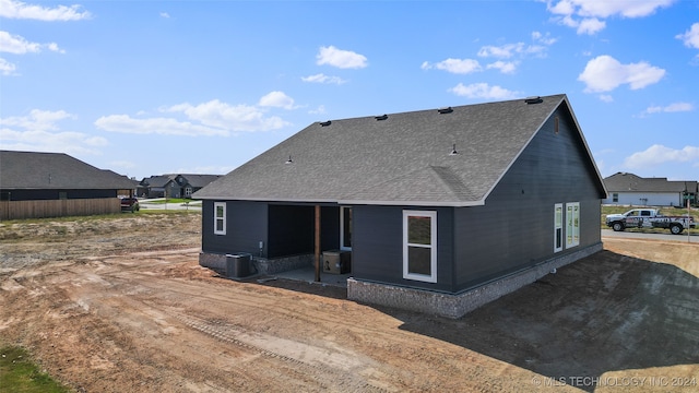 rear view of property with cooling unit