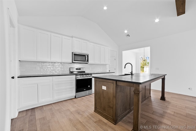 kitchen featuring a center island with sink, white cabinetry, light hardwood / wood-style flooring, and stainless steel appliances