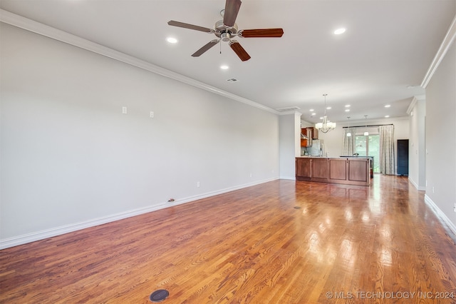 unfurnished living room with ceiling fan with notable chandelier, light hardwood / wood-style floors, and crown molding