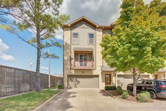 townhome / multi-family property featuring a balcony and a garage