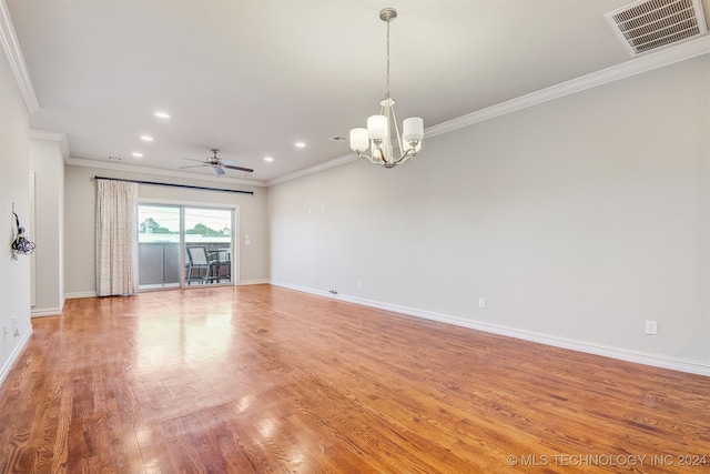 unfurnished living room featuring ceiling fan with notable chandelier, ornamental molding, and hardwood / wood-style flooring