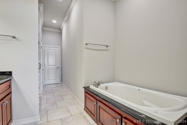 bathroom featuring ornamental molding, vanity, tile patterned floors, and a tub