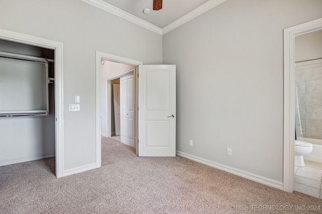 unfurnished bedroom featuring connected bathroom, ceiling fan, light colored carpet, and crown molding