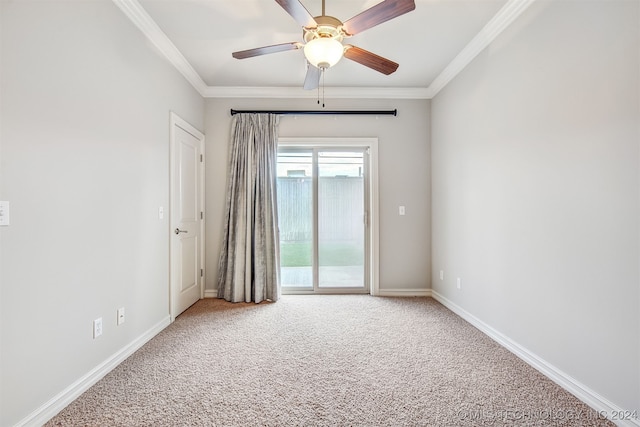 spare room featuring carpet flooring, ornamental molding, and ceiling fan