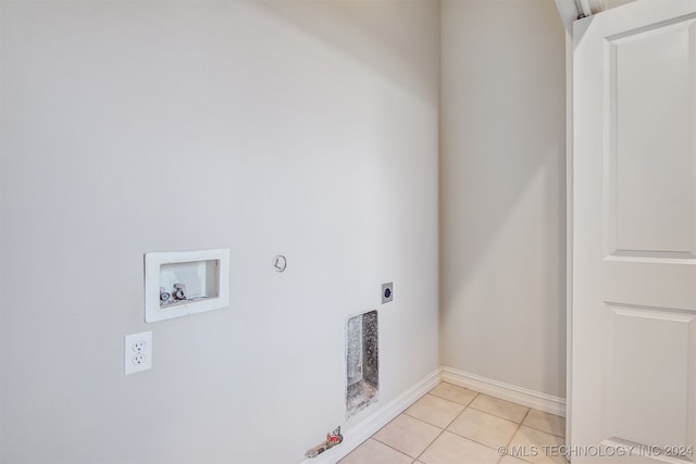 laundry area with hookup for a washing machine, hookup for a gas dryer, light tile patterned flooring, and hookup for an electric dryer