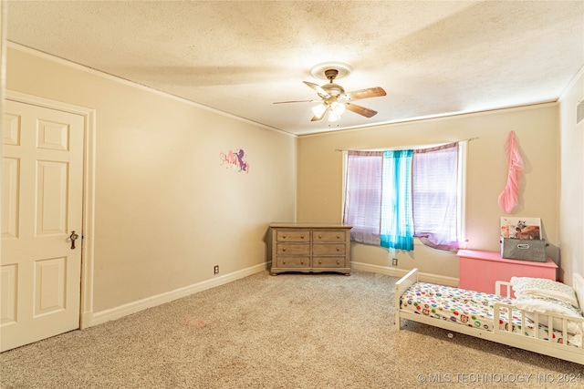 living area with a textured ceiling, crown molding, carpet flooring, and ceiling fan