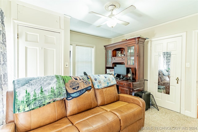 living room featuring ceiling fan, light colored carpet, and crown molding