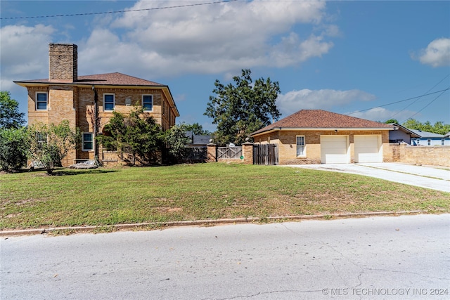 view of front facade with a front yard and a garage