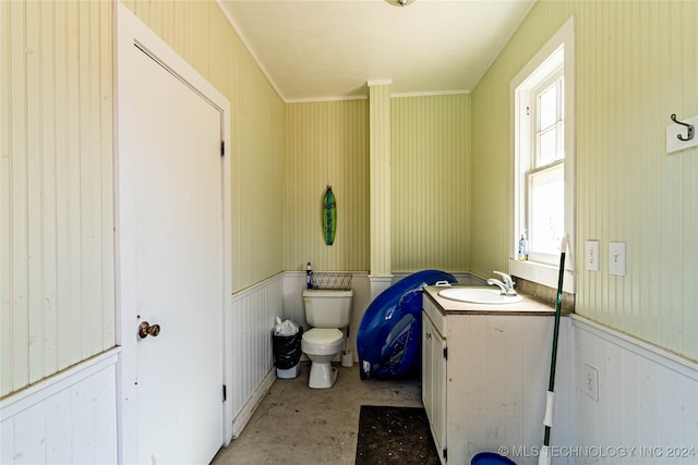 bathroom with ornamental molding, vanity, and toilet