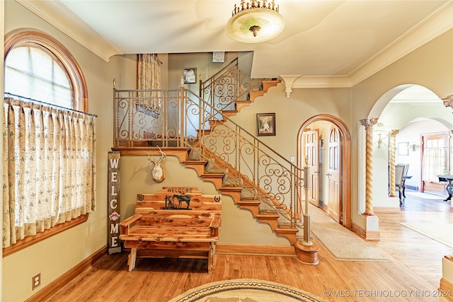 stairway featuring ornamental molding and hardwood / wood-style floors