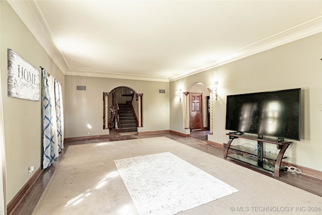 unfurnished living room with hardwood / wood-style flooring and ornamental molding