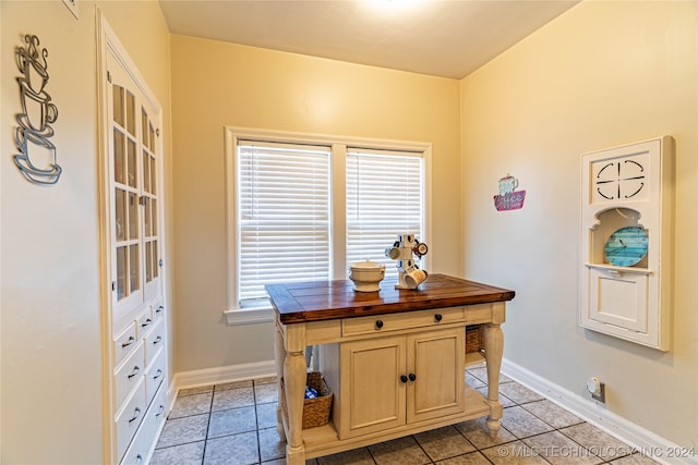 home office with light tile patterned floors