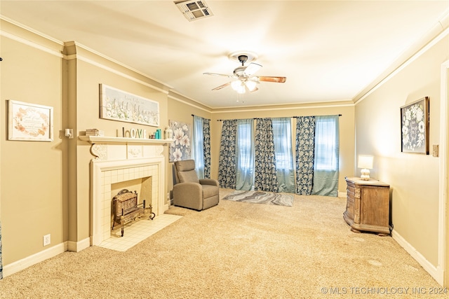 living area featuring ornamental molding, carpet, ceiling fan, and a fireplace