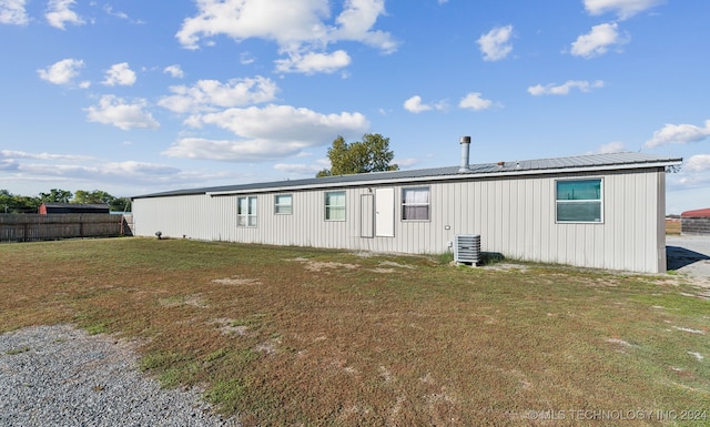 rear view of property with a yard