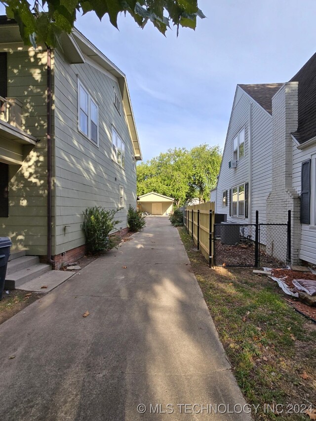 view of property exterior with a garage and an outbuilding