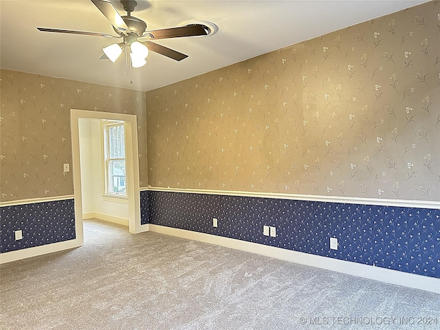 spare room with carpet floors and ceiling fan