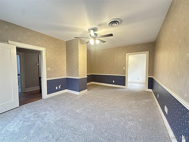 carpeted empty room with ceiling fan