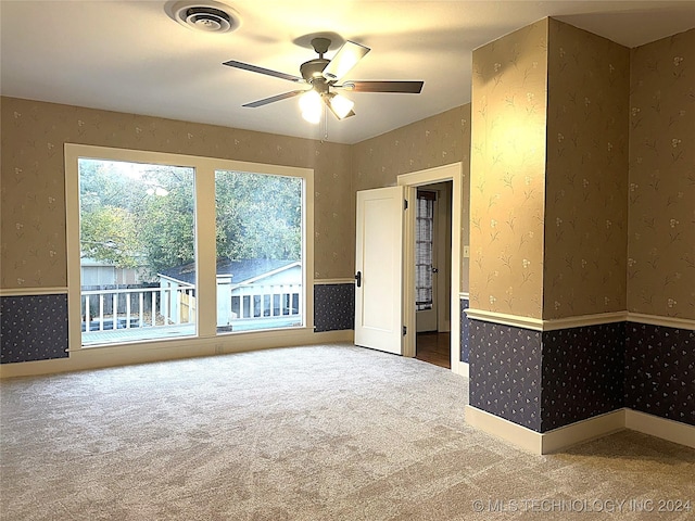 spare room featuring ceiling fan and carpet floors