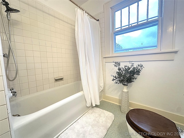 bathroom with shower / bath combo and toilet