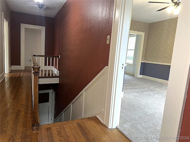420 K St SW, Ardmore, OK 73401 - staircase featuring wood-type flooring, a ceiling fan, a wainscoted wall, wallpapered walls, and baseboards