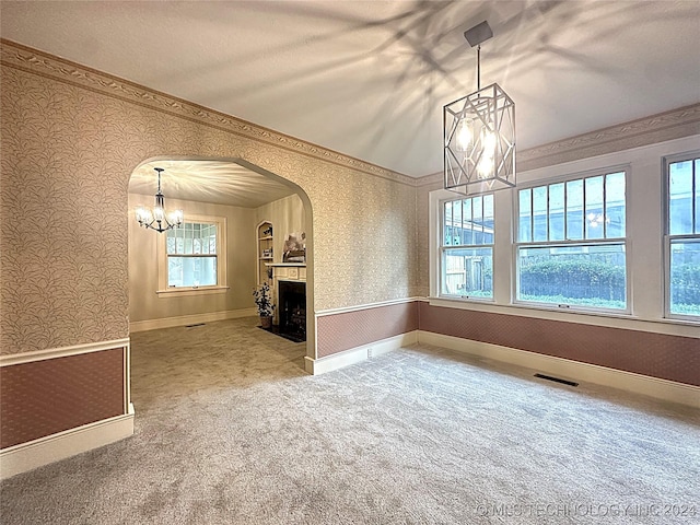 420 K St SW, Ardmore, OK 73401 - unfurnished dining area featuring a chandelier, wallpapered walls, arched walkways, carpet, and baseboards