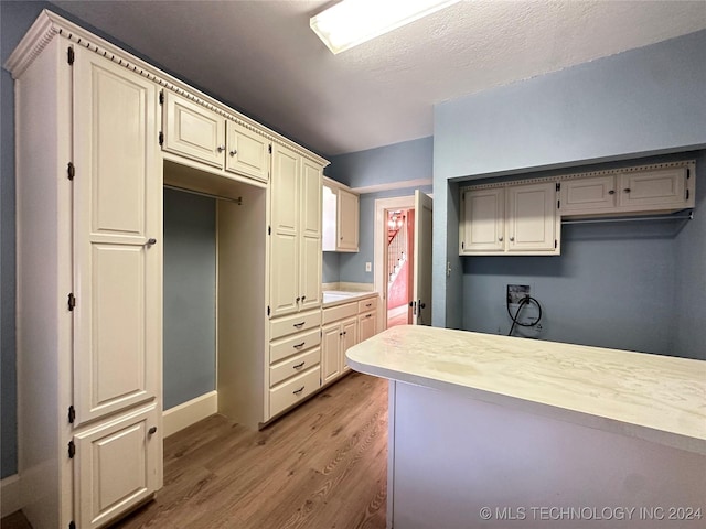 kitchen featuring cream cabinets and light wood-type flooring