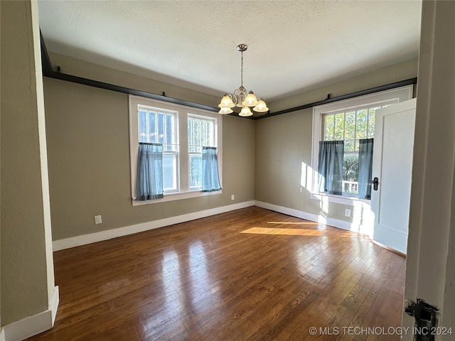 interior space featuring a chandelier, a textured ceiling, and hardwood / wood-style flooring