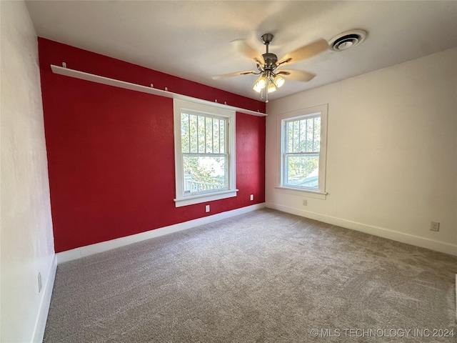 carpeted spare room with ceiling fan