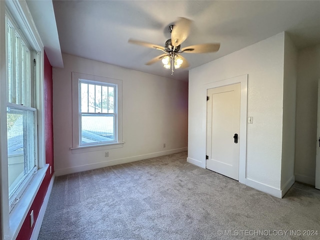 unfurnished bedroom with ceiling fan and light carpet