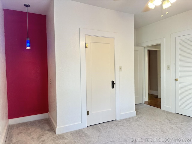 unfurnished bedroom featuring ceiling fan and light colored carpet