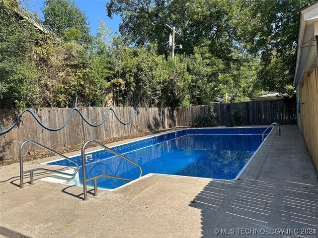 420 K St SW, Ardmore, OK 73401 - view of swimming pool featuring a fenced backyard and a patio area