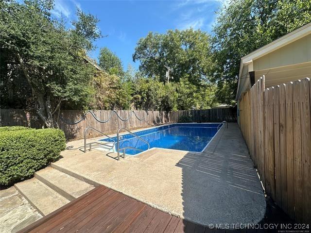 view of pool with a wooden deck