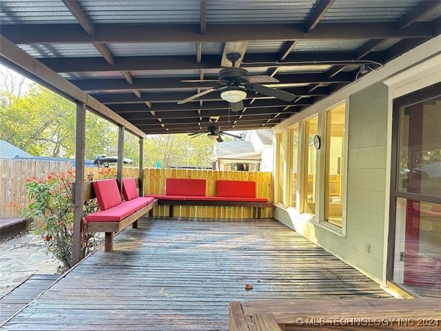 wooden terrace featuring ceiling fan